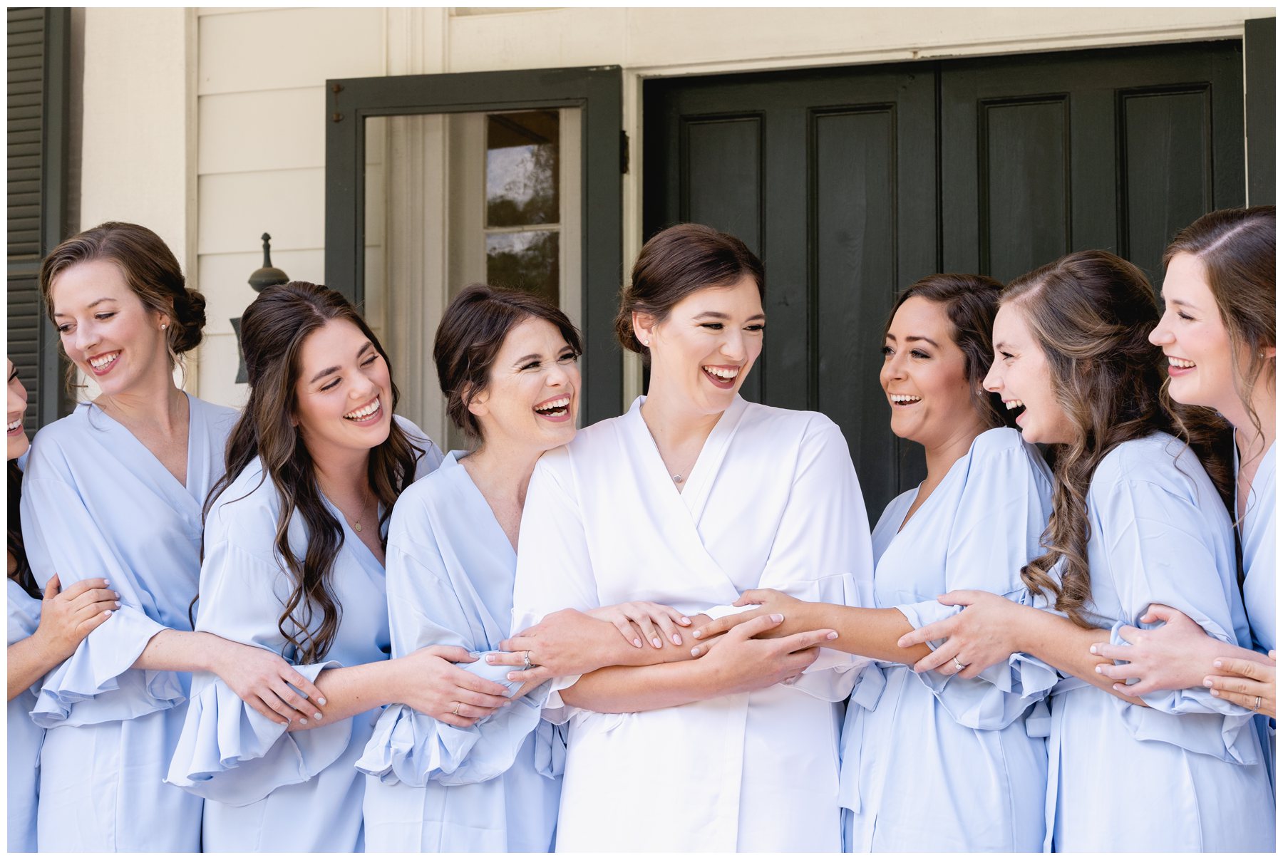 bride and bridesmaids laughting at Merango House,