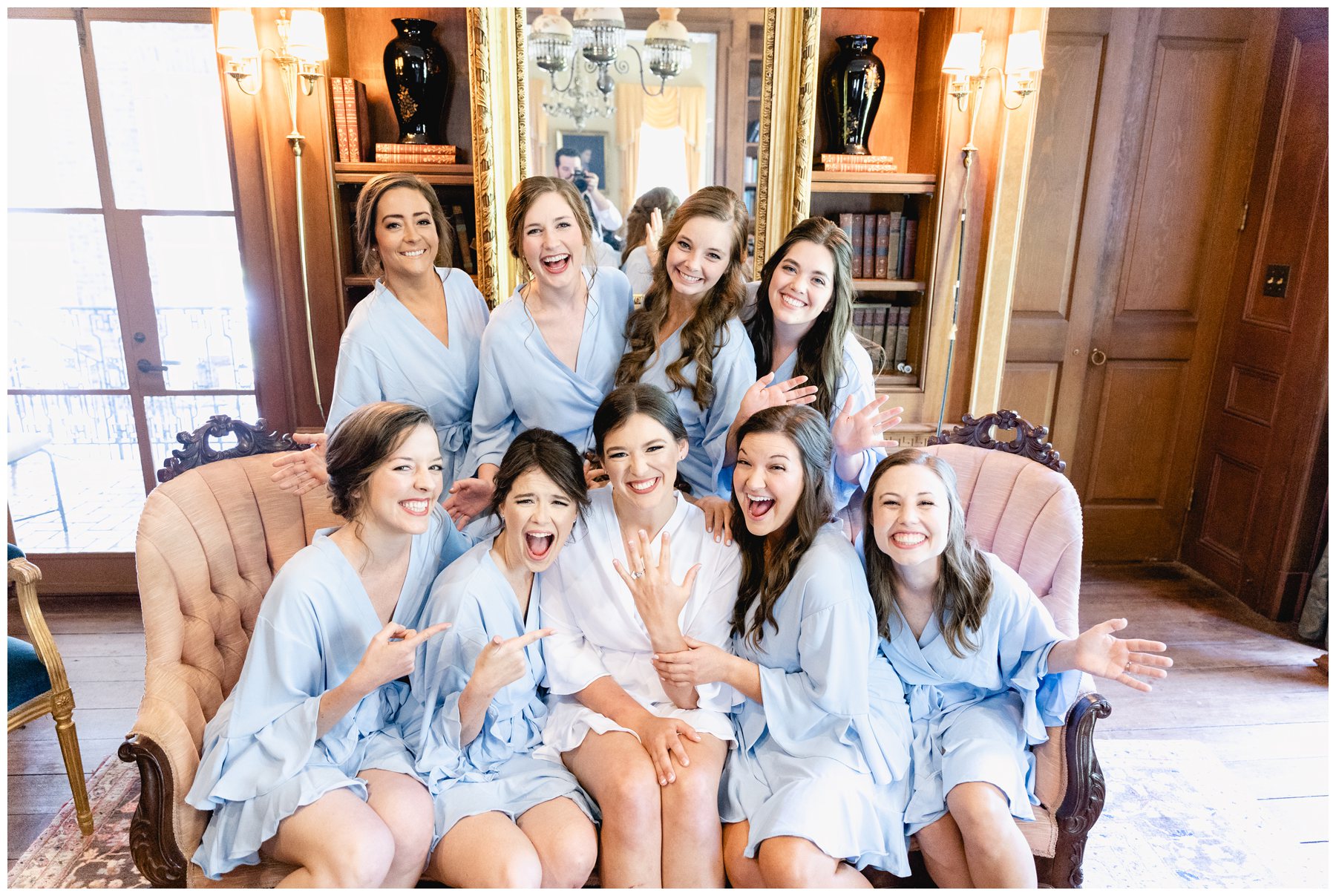 bridesmaids pointing at bride's ring,