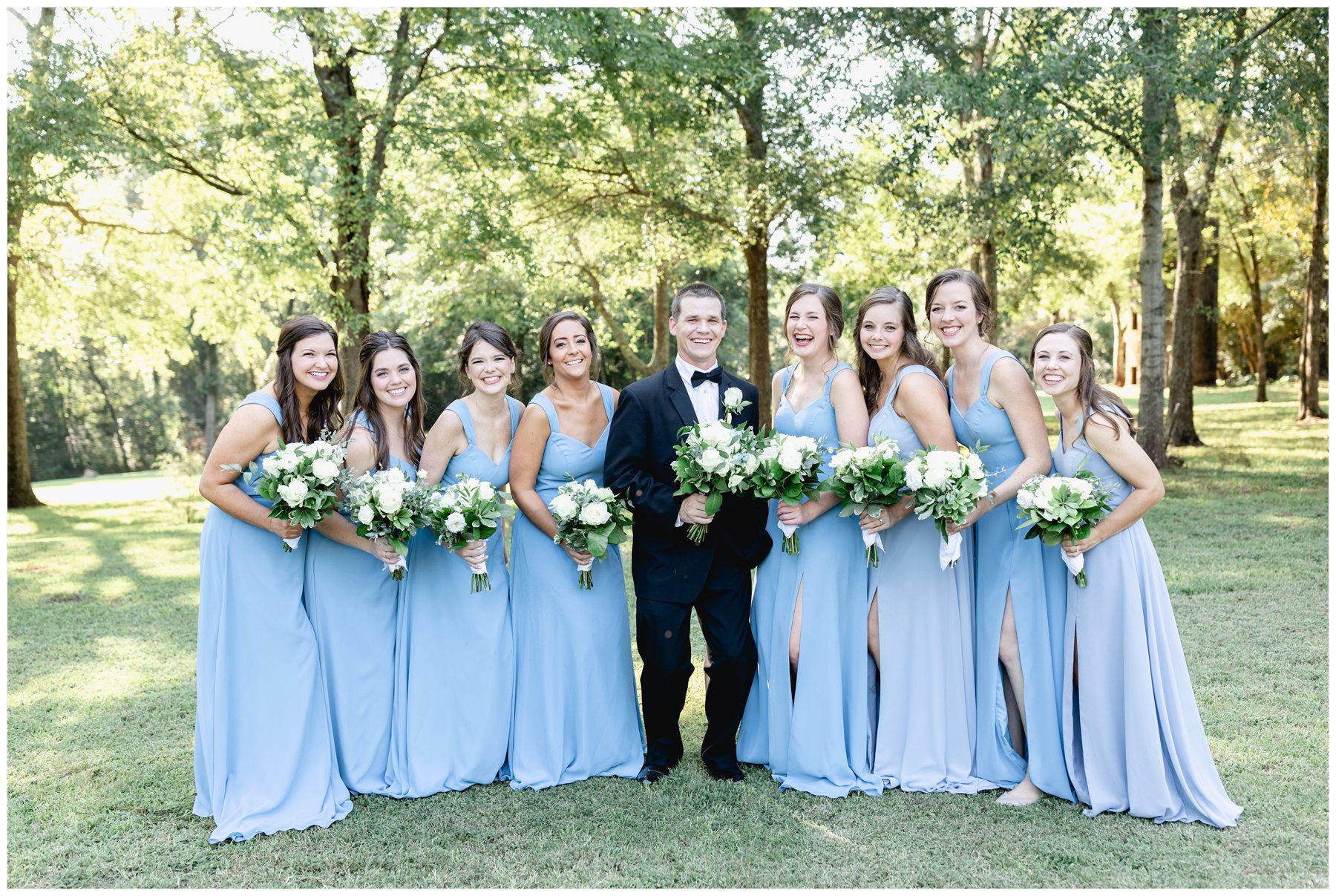 groom with bridesmaids holding bouquet,