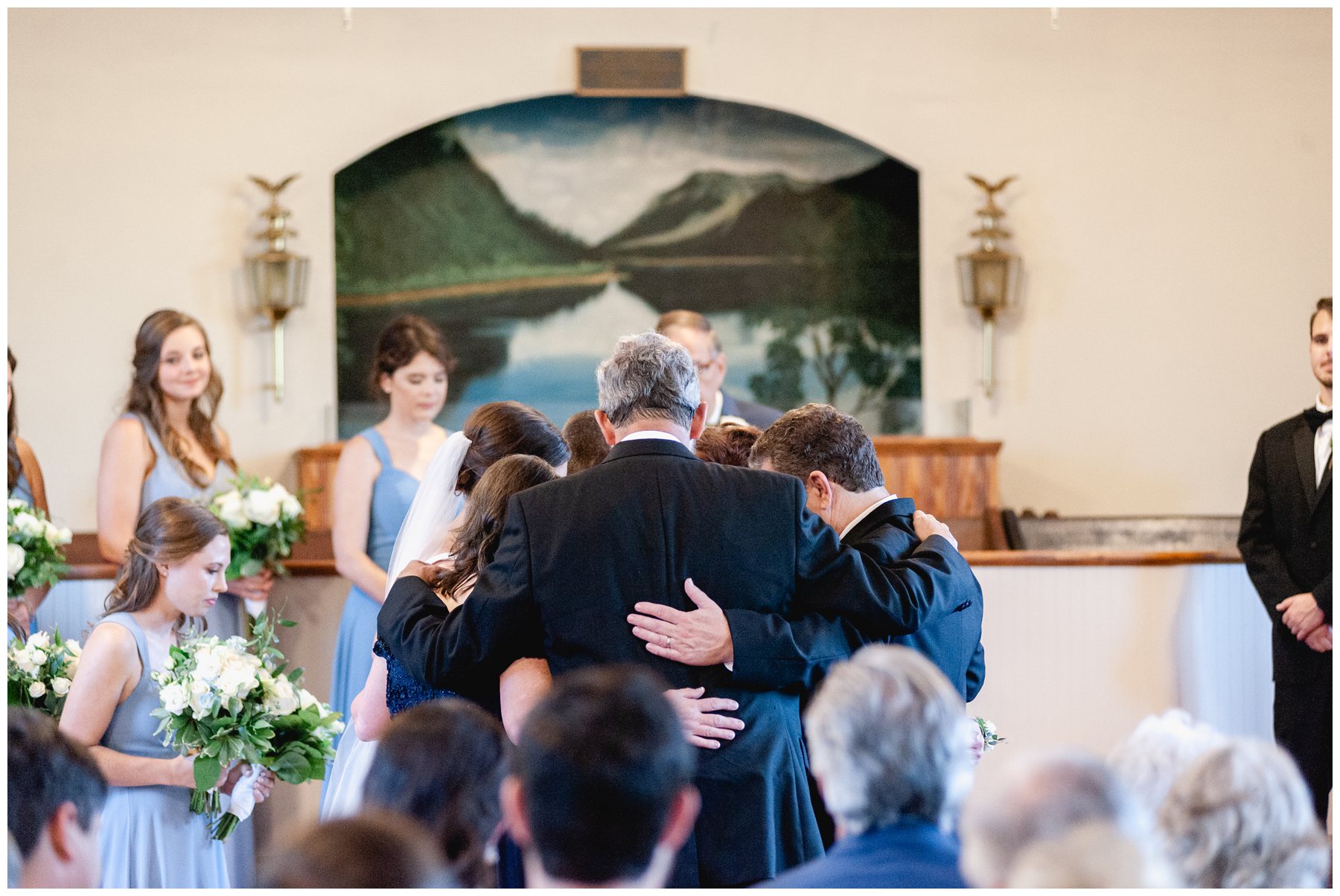 parents praying for bride and groom during ceremony,