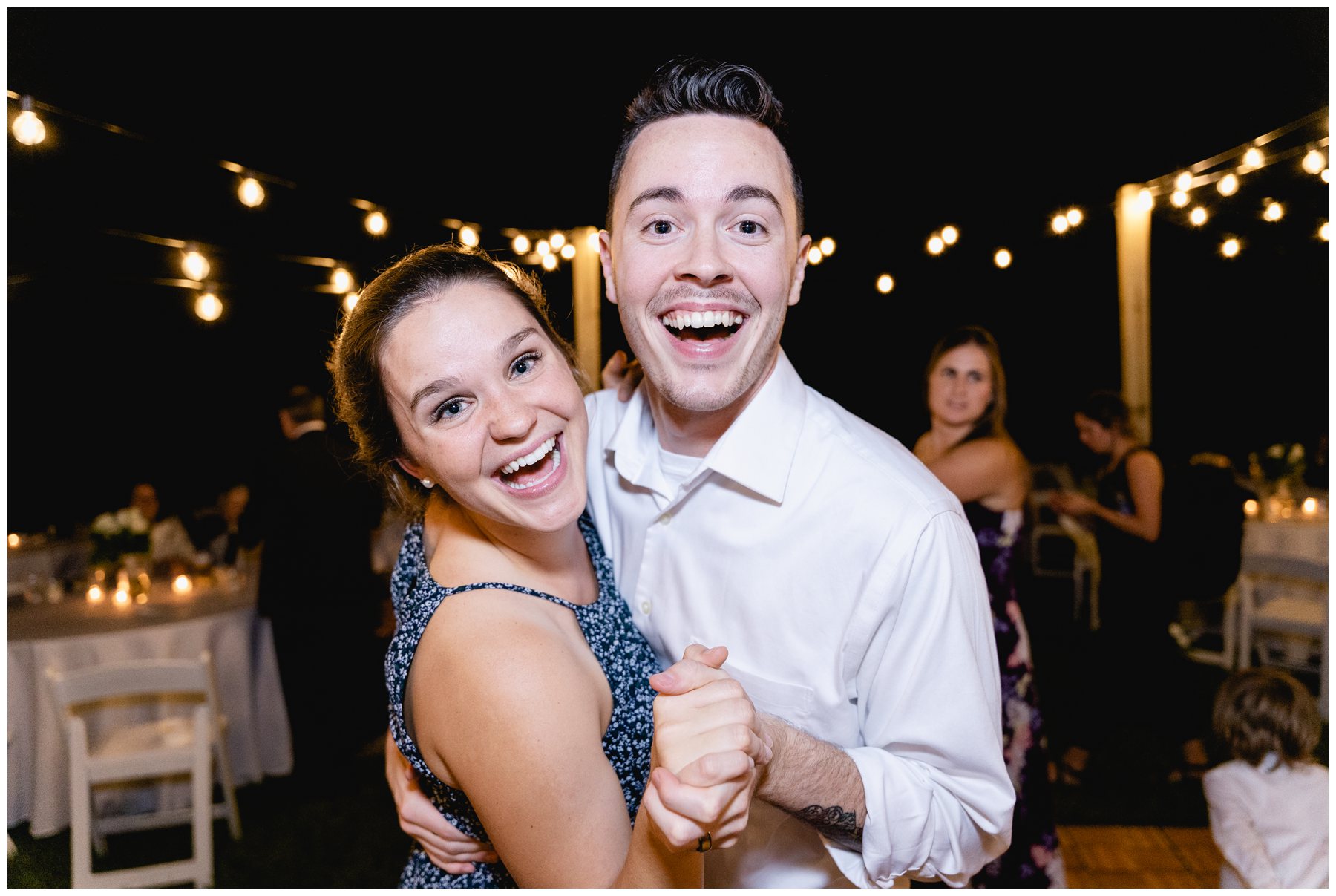 wedding guests smiling while dancing,