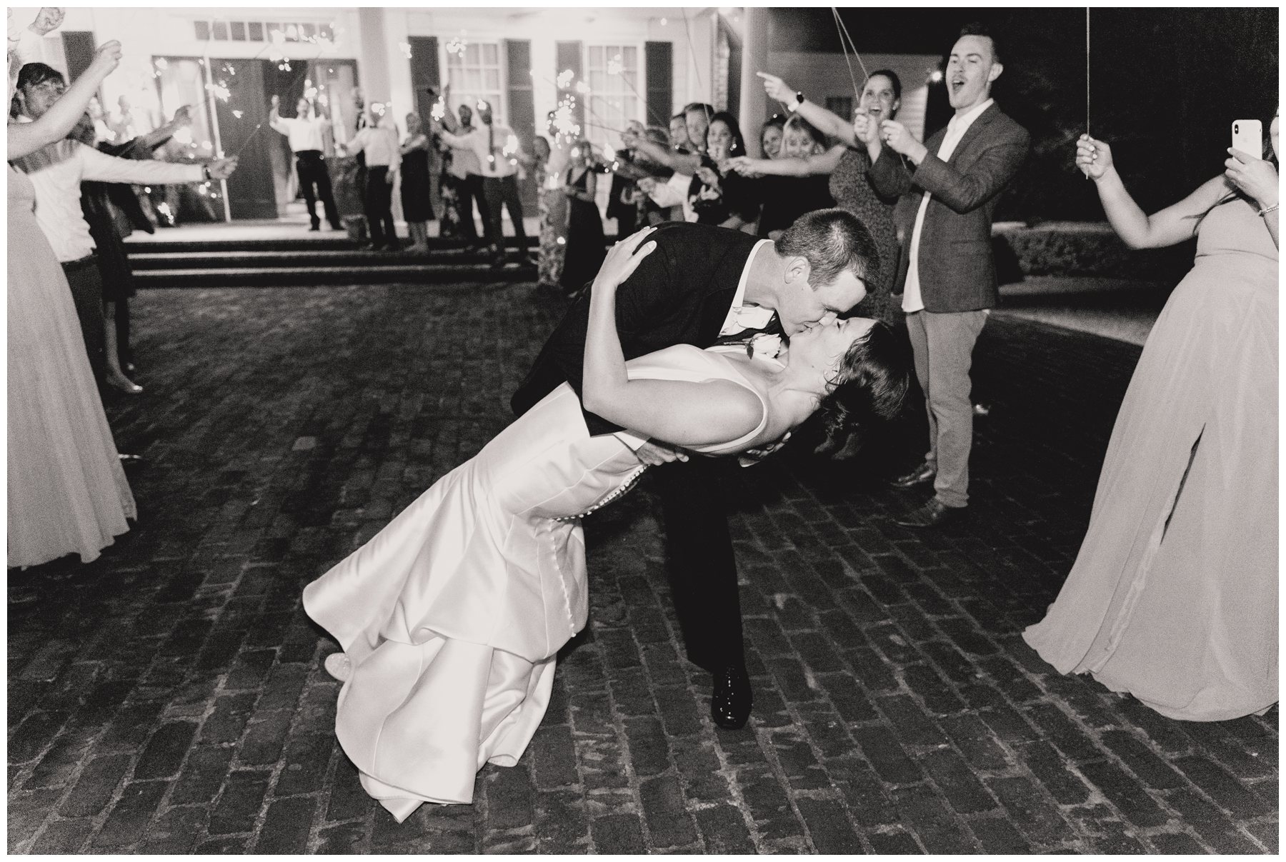 bride and groom kiss with sparklers behind them at Merango House in Lowndesboro AL,