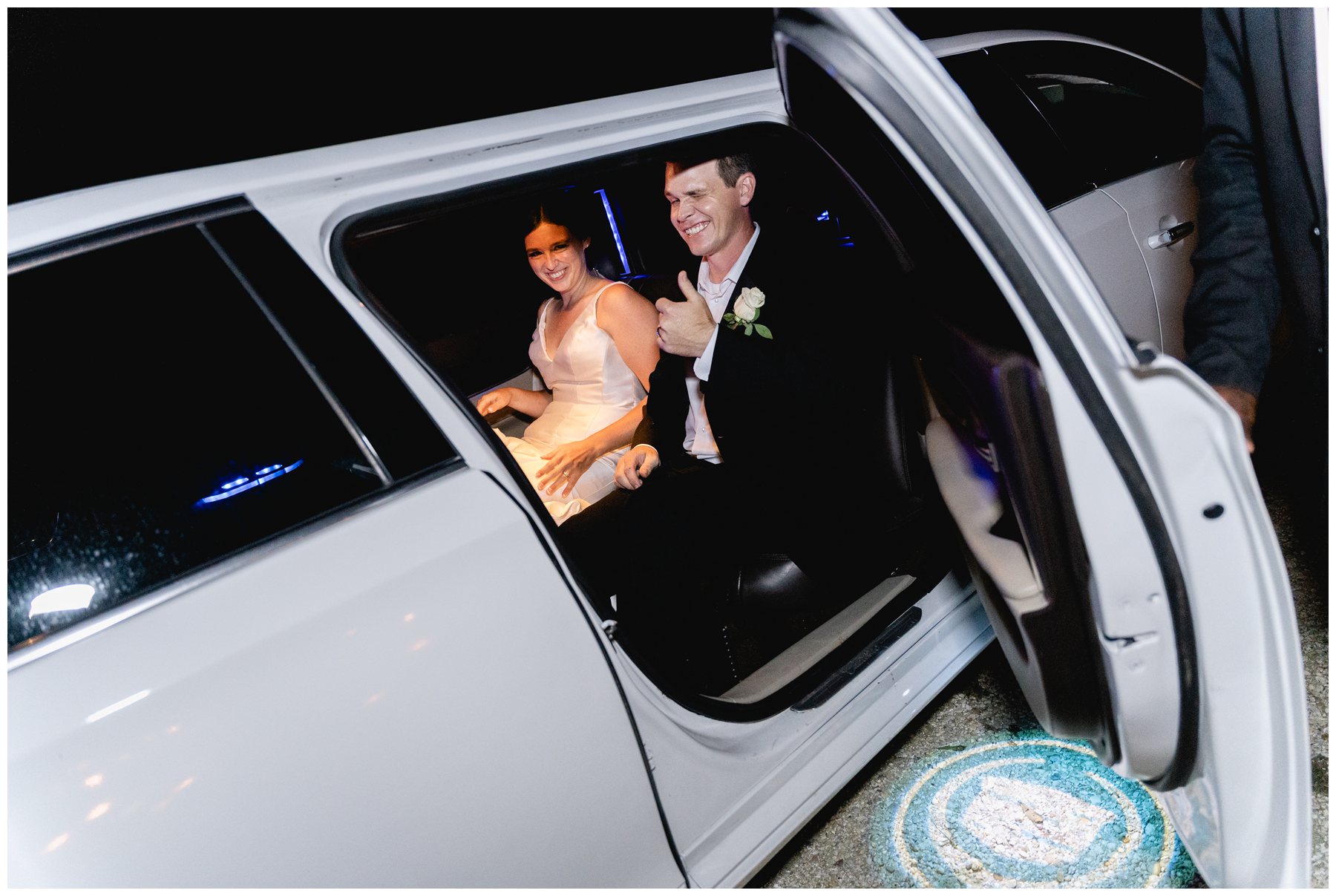 bride and groom in limo leaving wedding,